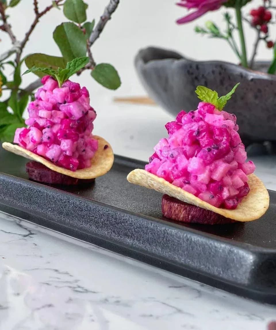 Bright pink fruit and sweet potato bites on crisp chips