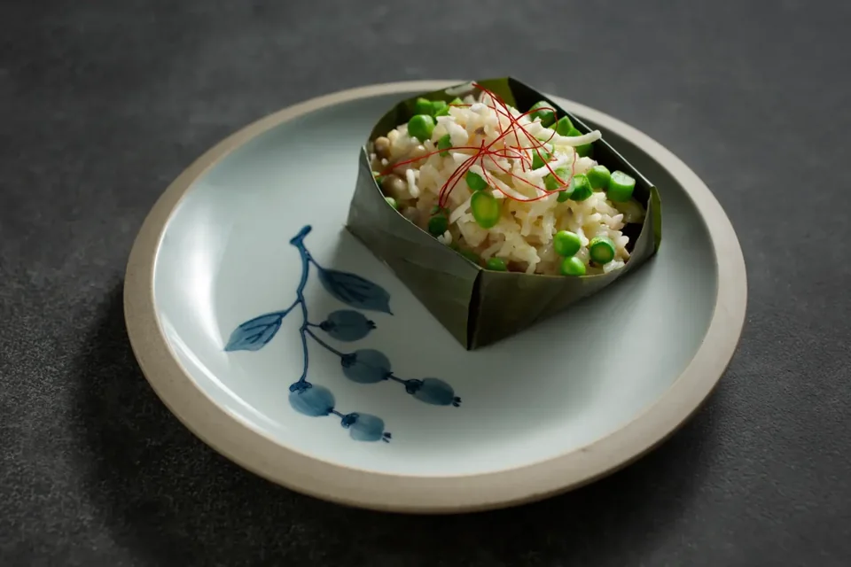 Vegetable risotto served in a folded banana leaf